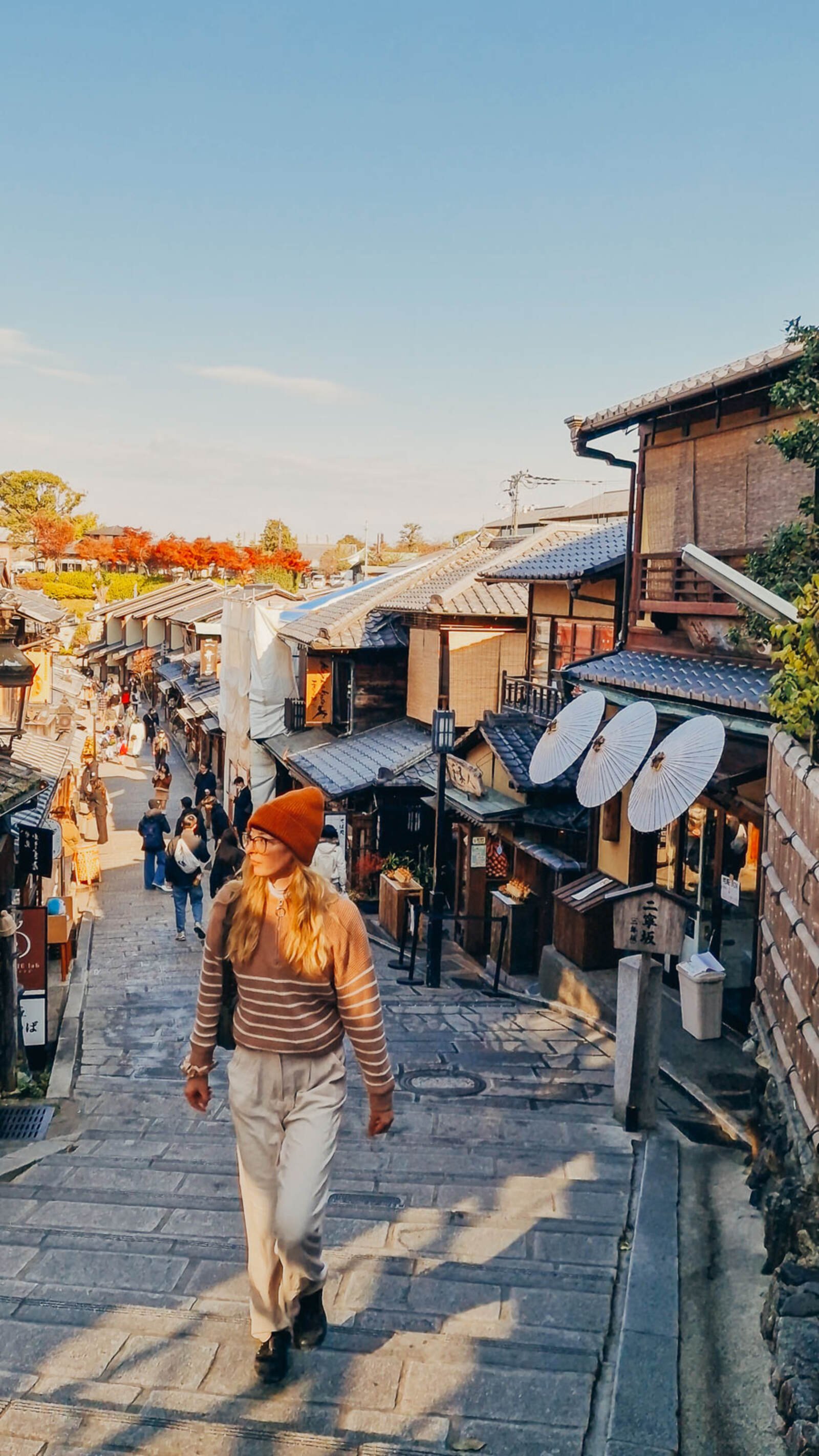 Helena walking up steps in a traditional japanese street with wooden houses