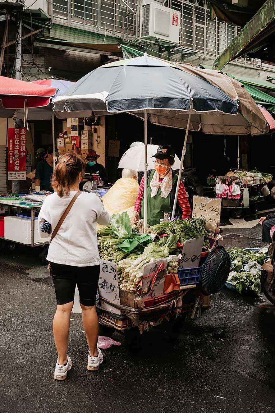 Taipei Eats food tour - woman selling vegetables at the market